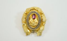 Victorian Gilt Metal Brooch Set With A Central Red Faceted Stone Enamelled Border And Realistically