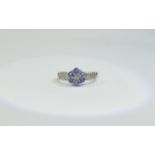 9ct White Gold Diamond and Tanzanite Cluster Ring central cluster, diamond set shoulders.