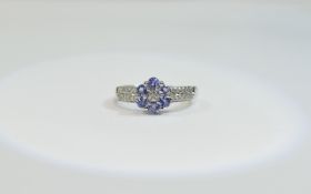 9ct White Gold Diamond and Tanzanite Cluster Ring central cluster, diamond set shoulders.
