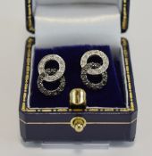 Pair Of 9ct Gold Black & White Diamond Stud Earrings, Modelled As Two Interlocking Rings,
