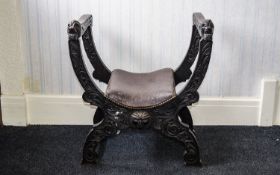 Carved Chair X framed chair with naive carved detail to legs, and carved lion head to arm rest.