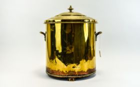 Brass Coal Bucket, with two handles and standing on three feet. 15 inches in height.