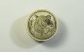 Etched Bone Circular Powder or Pill Box, the cover incised and stained with the head of a tiger