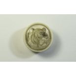 Etched Bone Circular Powder or Pill Box, the cover incised and stained with the head of a tiger