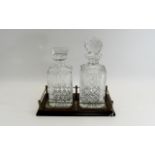 Glass Decanter Set comprising two decanters with star cut bases and stoppers,