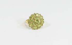 Peridot Cluster Ring, a circular cluster of round and oval cuts of the bright green peridots,