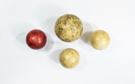 One Large and Three Small Ivory Snooker Balls, one of the smaller balls stained red