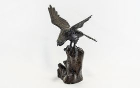 Bronze Bird of Prey Figure with outstretched wings, perched on a rock.