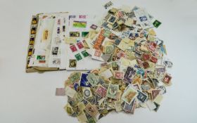 Huge tub of stamps from around the world, mostly off paper.
