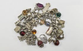 A Solid Silver and Heavy Curb Bracelet - Loaded with Over 33 Good Quality Vintage Charms. All