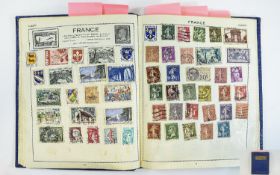 Blue Victory stamp album containing mix of old and new stamps