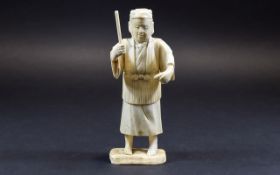 Chinese Ivory Figure of a Man about to hit a fish with a stick; mounted on a bone base;