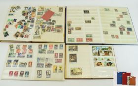 Selection of four stock books containing stamps from GB, the Phillipines, Middle East and so on.