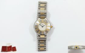 Cartier Must De 21 Quartz Gold and Steel Ladies Wrist Watch features a concealed clasp.