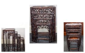 A SET OF CHINESE HONGMU QUARTETTO TABLES 19TH CENTURY Each with an inset panel top and pierced