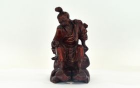 Carved Oriental Figure Small wood carved figure in traditional dress.
