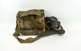 Pilots Gas Mask Black rubber mask with attached hose. Housed in field green canvas bag.
