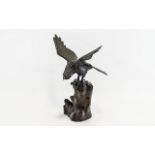 Bronze Bird of Prey Figure with outstretched wings, perched on a rock.