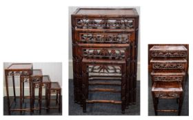 A SET OF CHINESE HONGMU QUARTETTO TABLES EARLY 20TH CENTURY Each with inset panel top and pierced