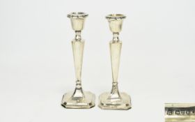 George V Pair Of Silver Candlesticks. Tapered columns on stepped base, hallmarked Chester 1912.