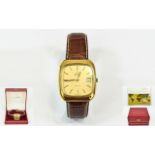 Omega Deville Gold Plated Quartz Day Just Gents Wrist Watch on an attached tan leather strap,