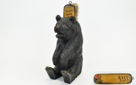 A Black Forest Carved Bear with a brush holder and glass eyes. 8.