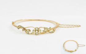 Antique Period 15ct Gold Hinged Bangle set with seed pearl and attached gold safety chain.