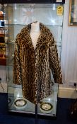 Ocelot Fur Coat Mid length vintage coat with revere collar and side seam pockets.
