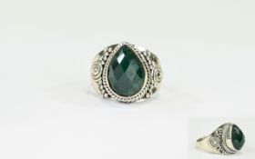 Emerald Solitaire Ring, a pear cut emerald of 8cts, with chequerboard faceting to the surface,