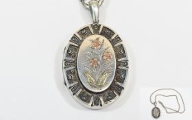 A Very Nice Quality and Vintage Oval Shaped Hinged Locket with raised floral decoration to central