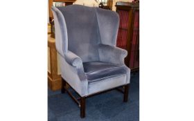 Wing Back Armchair Dark wood armchair upholstered in slate blue velour fabric.