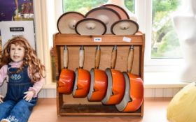 French 5 Piece Le Creuset Pan Set In Burnt Orange With Pine Shelving Unit