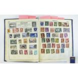 Blue Victory stamp album containing mix of old and new stamps