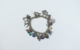 A Vintage Curb Bracelet Loaded with 22 silver and enamel old charms.