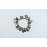 A Vintage Curb Bracelet Loaded with 22 silver and enamel old charms.