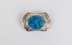 Ruskin Style Ceramic Brooch, a ceramic oval with mottled turquoise and blue glaze,
