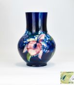 William Moorcroft Tube lined Globular Shaped Vase ' Orchids ' Design on Blue Ground. 10.