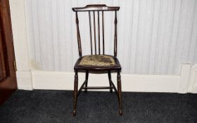 Bedroom Chair Small handmade dark wood chair with turned legs and upholstered seat.