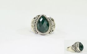 Emerald Solitaire Ring, a pear cut emerald of 8cts, with chequerboard faceting to the surface,