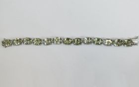 Green Amethyst Tennis Bracelet, 70cts of oval cut green amethyst set in platinum vermeil and silver,