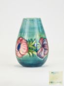Moorcroft Modern Tube lined Small Vase ' Anemone ' Design on a Green / Blue Ground.
