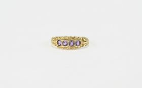 Amethyst and 9ct Gold Ring, a row of four round cut amethysts, each in a square frame,