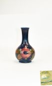 William Moorcroft Small Bottle Shaped Vase ' Pomegranates ' Design on Blue Ground. c.1930's.