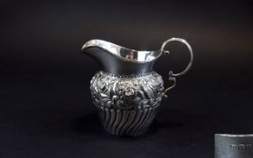 Victorian Ornately Decorated Helmet Shaped Silver Milk Jug with Half Fluted Body and Embossed