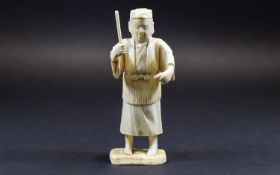 Chinese Ivory Figure of a Man about to hit a fish with a stick; mounted on a bone base;