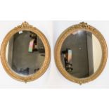 Pair Of Oval Ornate Framed Gilt Mirrors Two mirrors with decorative molded frames. A good