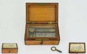 A Miniature Music Box, 5 x 3.1/4 x 2 Inches, Contained In a Mahogany Case.