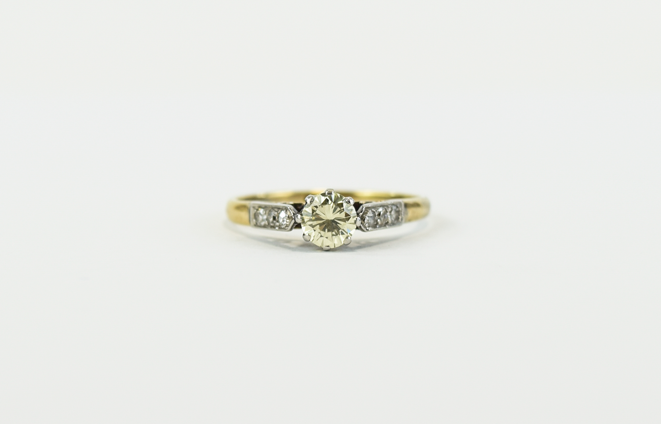 18ct Gold Set Single Diamond Ring with Six Small Diamonds to Shoulders. Diamond of Good Colour.