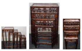 A SET OF CHINESE HONGMU QUARTETTO TABLES EARLY 20TH CENTURY Each with inset panel top and pierced