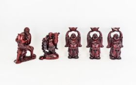 Oriental Buddha Figures Five in total, fashioned in red resin,